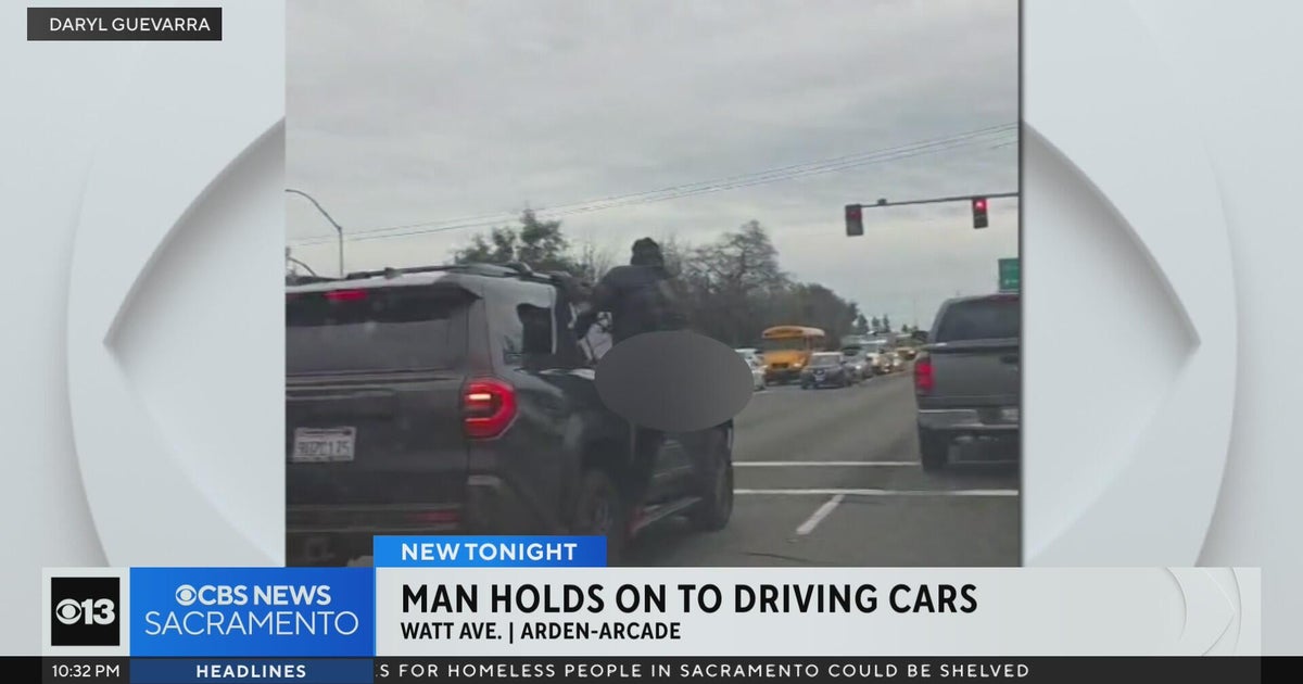 Video captures man holding onto moving cars in Sacramento County