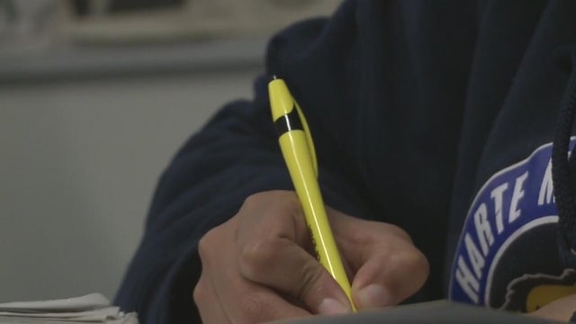Student Holding a Pen 