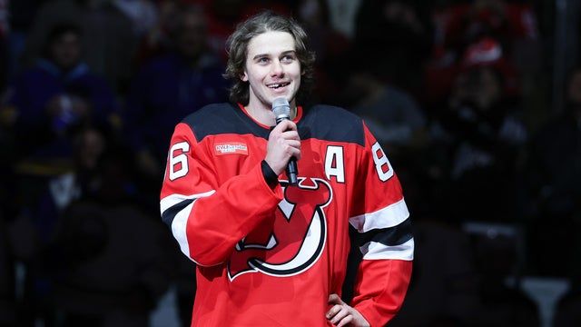 Jack Hughes #86 of the New Jersey Devils salutes the crowd in his first game back since scoring the game winning goal to earn a Gold Medal for Team USA in the Olympics, before a game between the Buffalo Sabres and New Jersey Devils at Prudential Center on February 25, 2026 in Newark, New Jersey. 