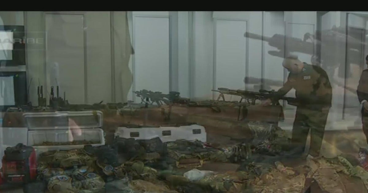 Cuban officials show alleged weapons found on boat shot