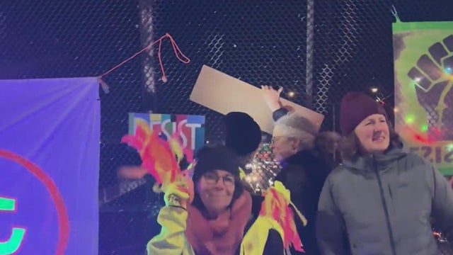 People in costumes on a highway overpass 