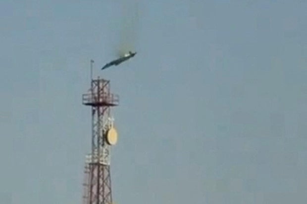 A burning aircraft falls from the sky in Al Jahra, in this still image obtained from social media video