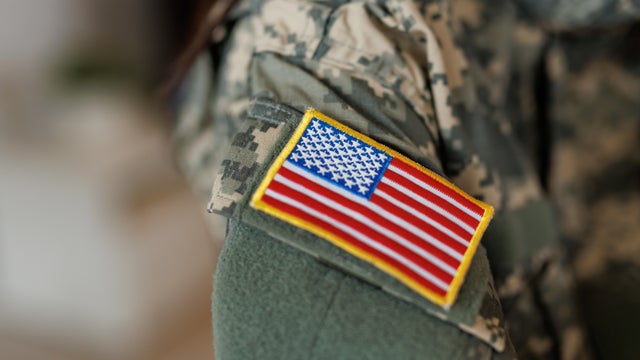 Soldier wearing camouflage uniform with U.S. flag patch 