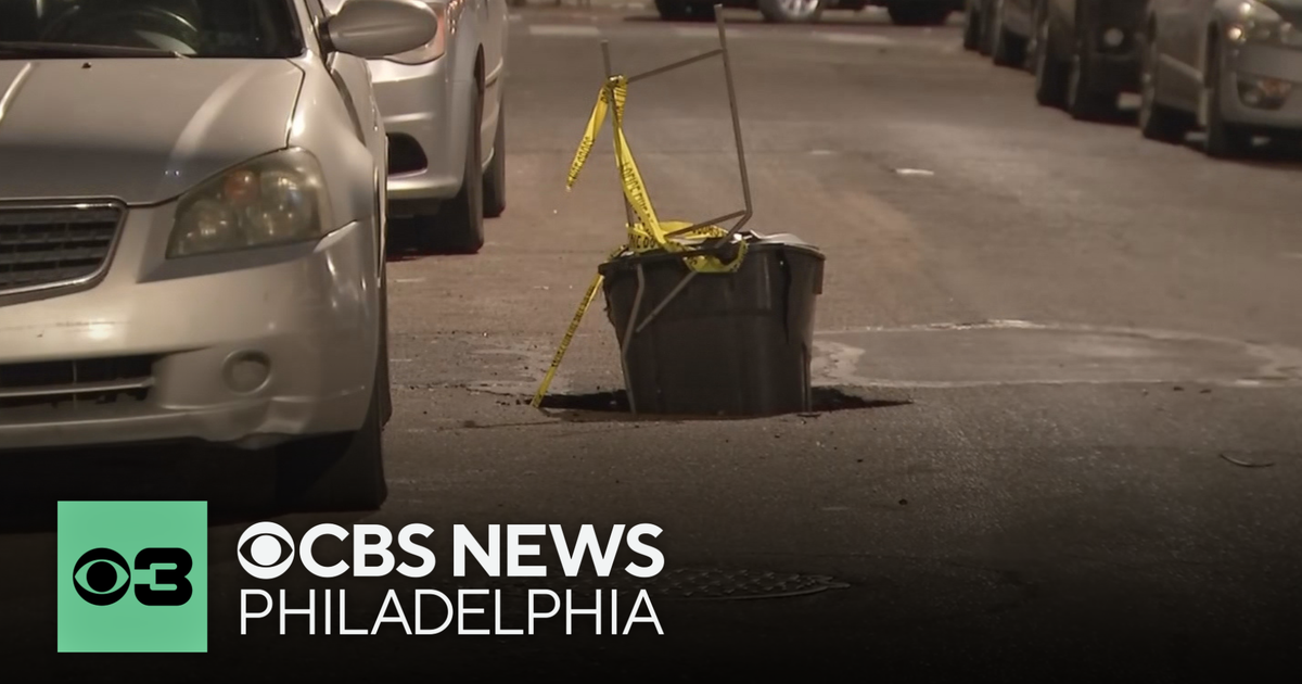Neighbor uses trash can to fill sinkhole in Philadelphia