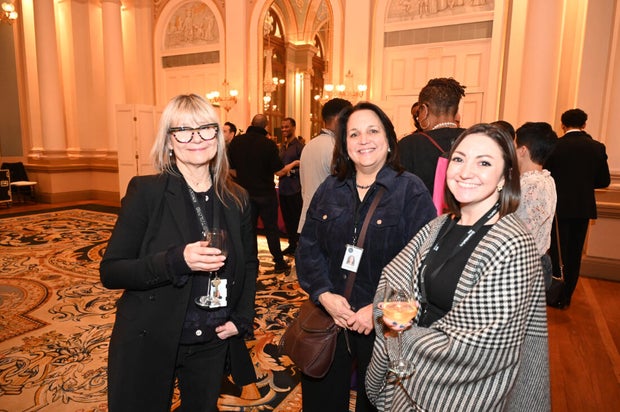 People post for photos at Alvin Ailey American Dance Theater Party at Ensemble Arts 