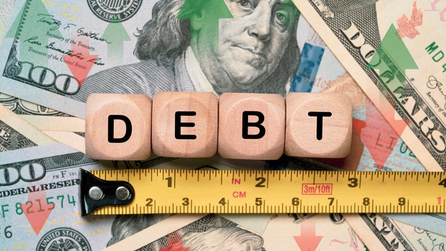 Debt wording with measure tape on USD dollar banknote for united states of America's or USA public debt is high and the debt ceiling needs to be raised concept. 