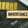 gold, banknotes and wooden boards with the word inheritance 