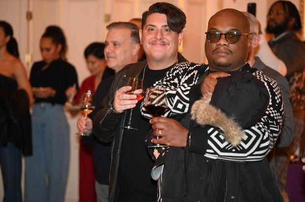 People post for photos at Alvin Ailey American Dance Theater Party at Ensemble Arts 