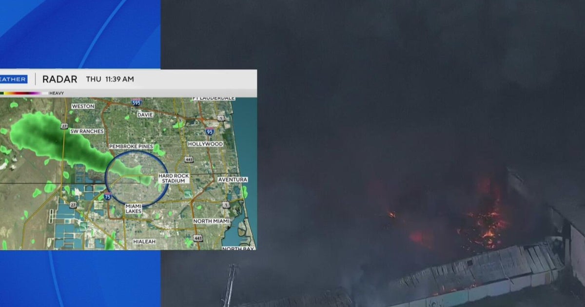Thick, black smoke fills sky above northwest Miami-Dade as massive warehouse fire rages