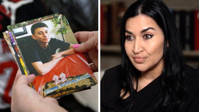 Rachel Reyes looks at a photo of her son, Ruben Ray Martinez 