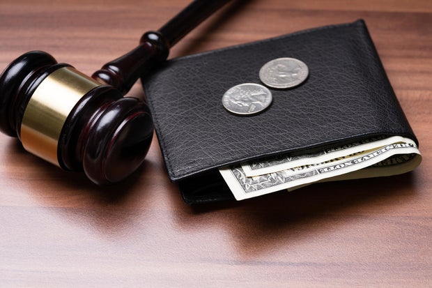 Pocket With Currency Near Judge Gavel Over Desk 
