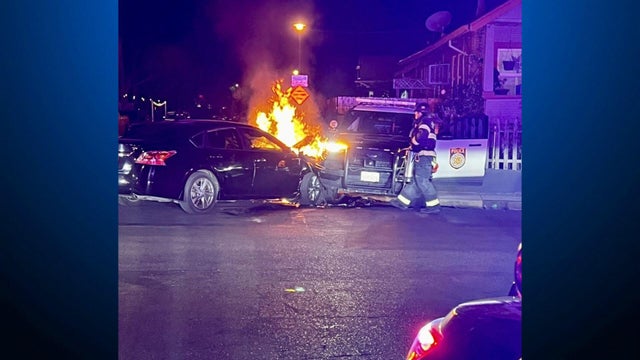 A vehicle on fire after crashing into a police patrol vehicle 