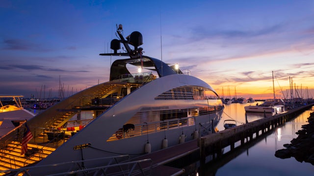View of the yacht club and marina with large yachts at sunset in pattaya. 
