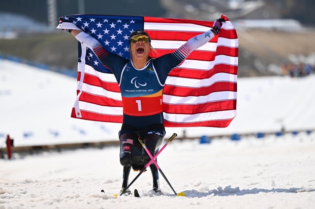 Oksana Masters of Team USA celebrates after winning gold in the Para cross-country skiing sprint sitting final at the Paralympics, March 10, 2026, in Val di Fiemme, Italy. 