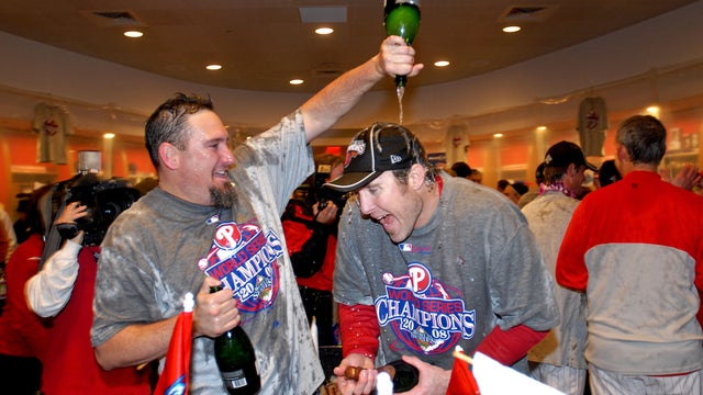 Scott Eyre of the Philadelphia Phillies, left, pours champag 