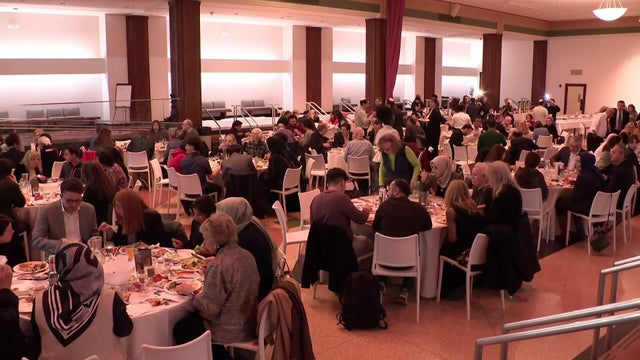 Individuals eating a meal at tables 