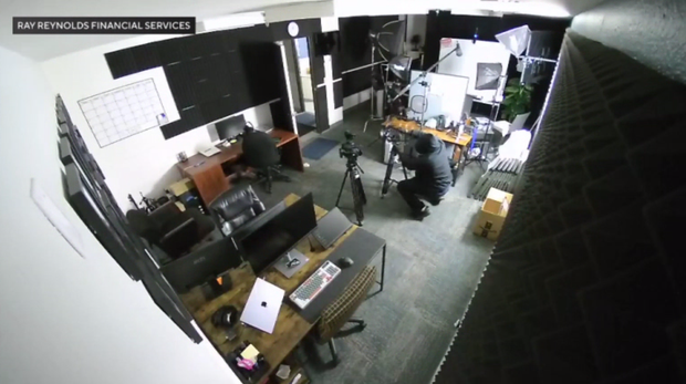 suspect removing cameras from tripods inside Ray Reynolds Financial Services in Riverside on March 12, 2026.