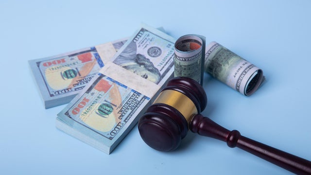 Gavel and money representing legal financial settlement 