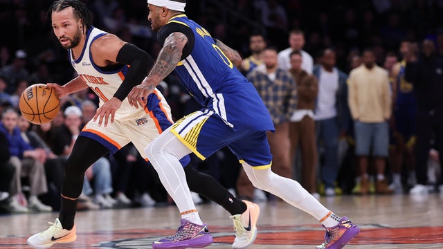 Jalen Brunson #11 of the New York Knicks is defended by Gary Payton II #0 of the Golden State Warriors during the fourth quarter of the game at Madison Square Garden on March 15, 2026 in New York City. 