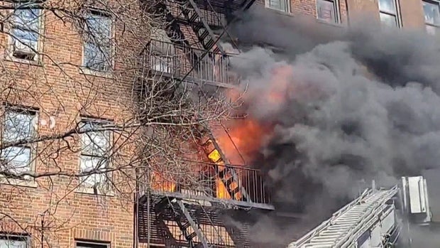 Flames shoot out the windows of a Bronx building 