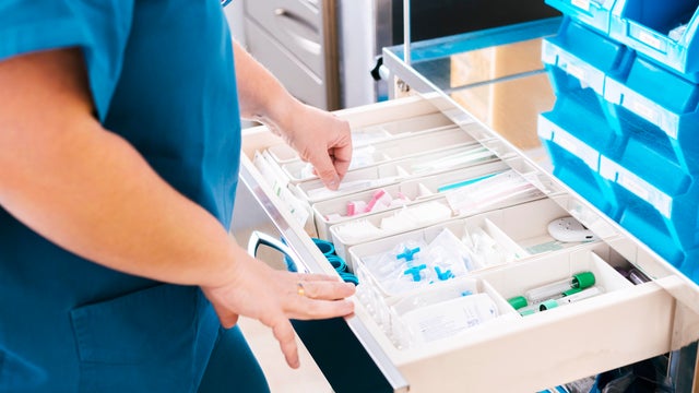Nurse with medical supplies at hospital 