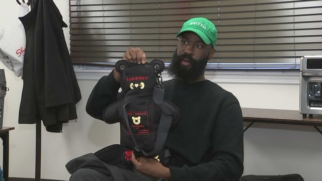 Antoine Johnson holds up the A Kidney Spicy bears bag 