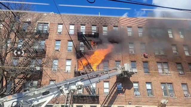 Flames shoot out the windows of a Bronx building 
