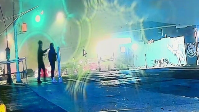 Man approaching a woman on the sidewalk from behind 