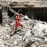 Emergency personnel work at the site of a strike on a residential building amid the U.S.-Israeli conflict with Iran, in Tehran, Iran, March 23, 2026. 