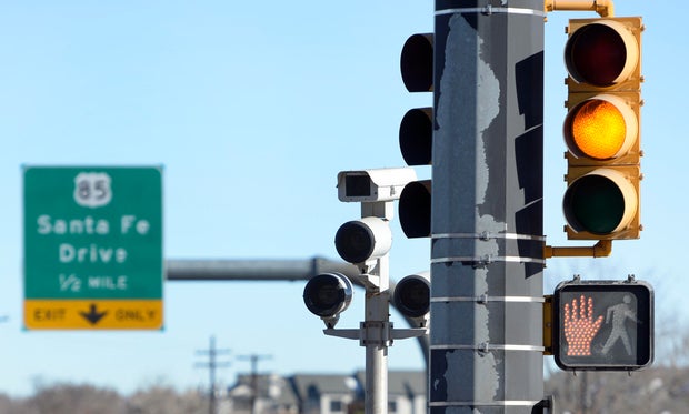 Supporters trying to ban red light cameras and photo radar cameras go door to door in Sheridan to collect signatures for a ballot measure. 