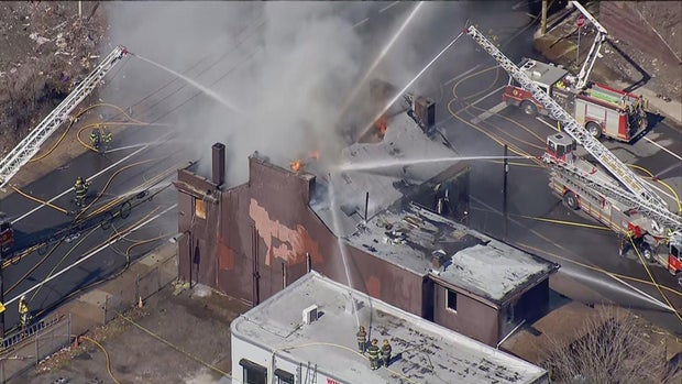 Fire and smoke are coming from a brick building on Frankford Avenue, firetrucks and crews are on the scene 