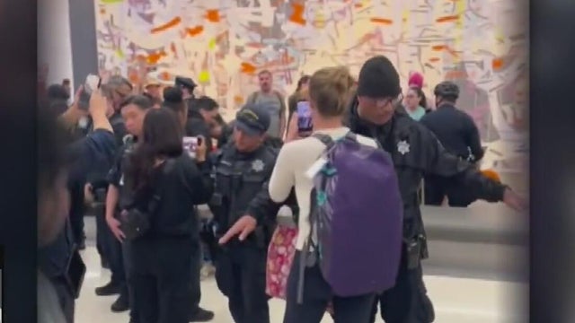 Police officers stand next to each other forming a barrier 