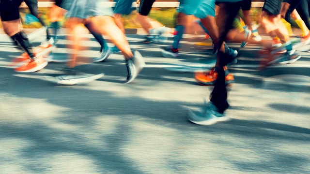 Marathon runners on a street, blurry image. 