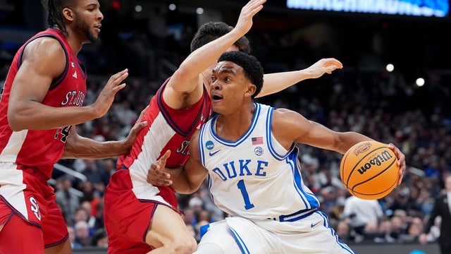 Duke guard Caleb Foster (1) drives as St. John's guard Dylan Darling defends during the second half in the Sweet 16 of the NCAA college basketball tournament, Friday, March 27, 2026, in Washington. 