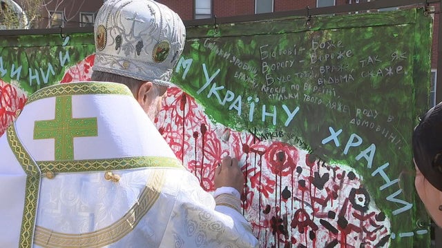 The archbishop adds to the painting 