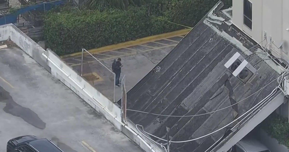 Two cars trapped underneath partially collapsed walkway in Hallandale Beach