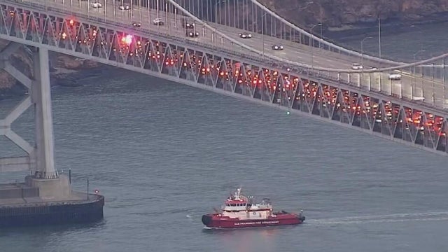 A San Francisco Fire Department water vessel underneath the Bay Bridge 