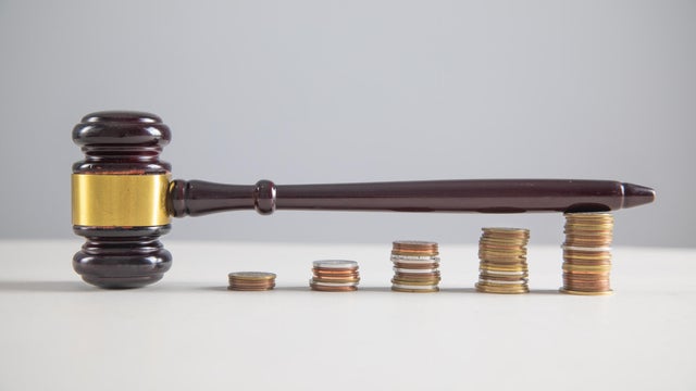 Judge gavel and coins on the table. 