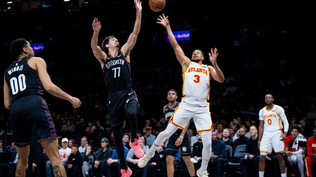 Atlanta Hawks guard CJ McCollum (3), defended by Brooklyn Nets guard Ben Saraf (77), shoots a two-pointer during the first half of an NBA basketball game, Friday, April 3, 2026, in New York. 