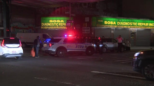 Police car on a street corner in Brooklyn at night 