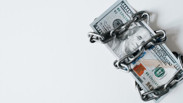 Economic crisis, financial business problems concept. Top view one hundred dollar bill chained, copy space 