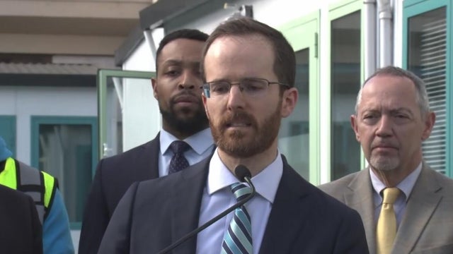 A man stands at a podium during a news conference 