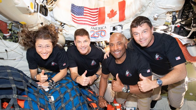 From left, Artemis II crewmates Christina Koch, Jeremy Hansen, Victor Glover and Reid Wiseman pause for a group photo inside the Orion spacecraft on their way home in this handout image provided by NASA. 