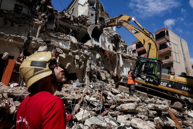 Rescuers assisted by heavy machinery work at the site of an Israeli strike carried out two days earlier, in the southern suburbs of Beirut, Lebanon, April 10, 2026. 