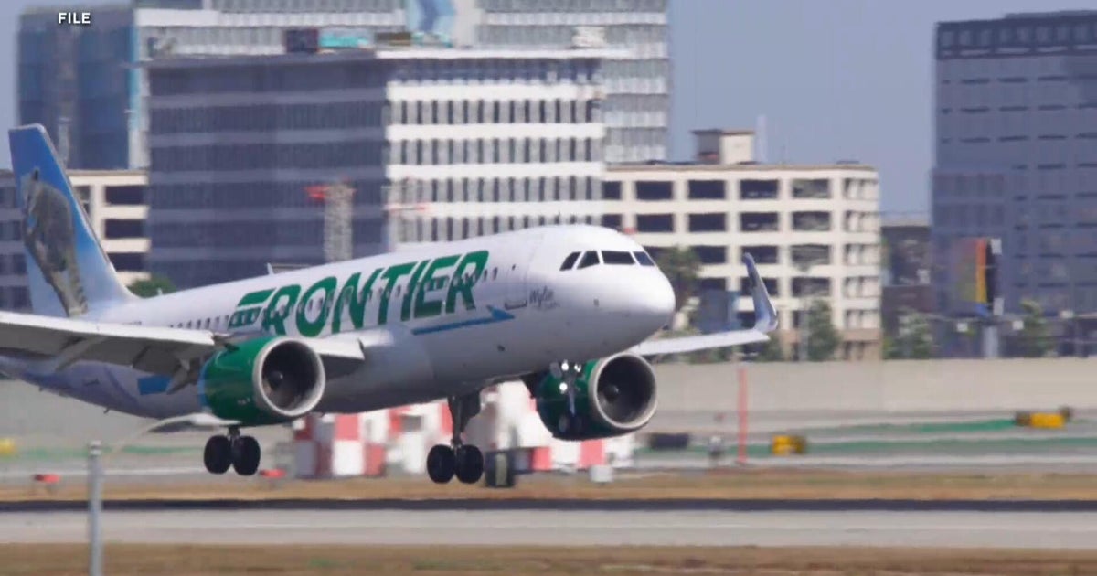 FAA investigating close call between plane and two trucks at LAX