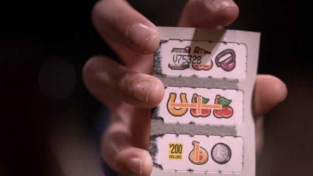 Sana Anetipa (cq) daughter held up a winning ticket of 200.00 that her father purchased while he played pull tabs Wednesday March 6, 2019 at Skinner's Bar in St.Paul, MN.] Jerry Holt &sbquo;&Auml;&cent; Jerry.holt@startribune.com 
