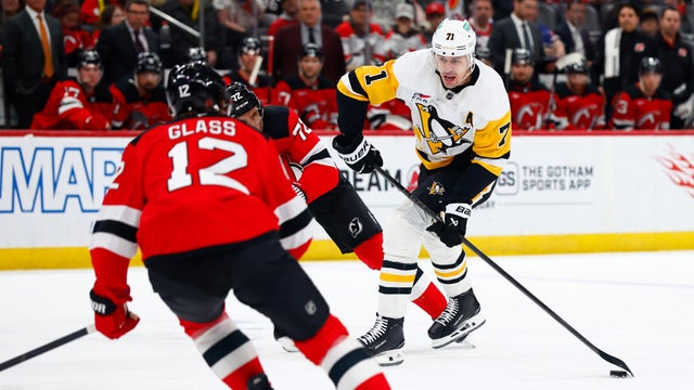 Pittsburgh Penguins center Evgeni Malkin (71) shoots against New Jersey Devils centers Cody Glass (12) and Nick Bjugstad (72) during the first period of an NHL hockey game, Thursday, April 9, 2026, in Newark, N.J. 