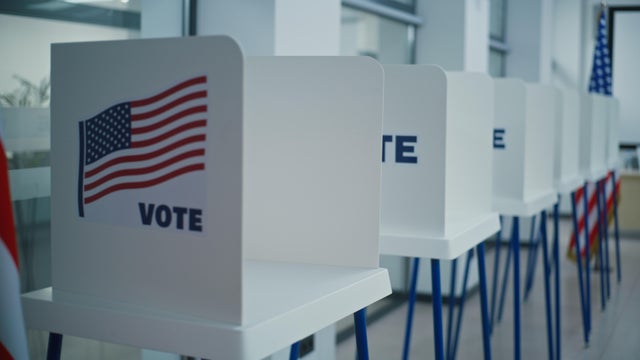 Voting booths with American flag logo in polling station office. 