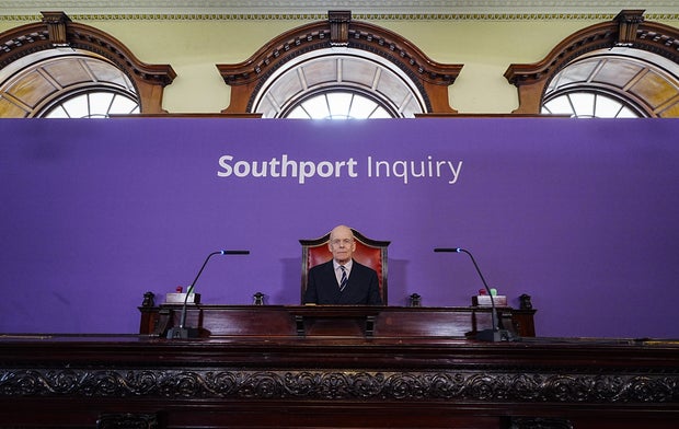 Chair Sir Adrian Fulford sits inside the hearing room ahead of the start of the inquiry into the deadly knife attack in Southport, England, July 7, 2025. 