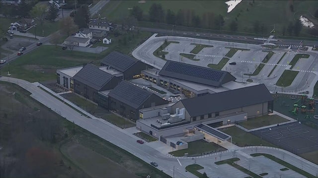 Close Up Shot Focused on Yellow Tape Showing Text Police Line Do Not Cross. Restricted Area of a Crime Scene. Bokeh Background with Flickering Siren Lights. Forensics Team Working on a Case 